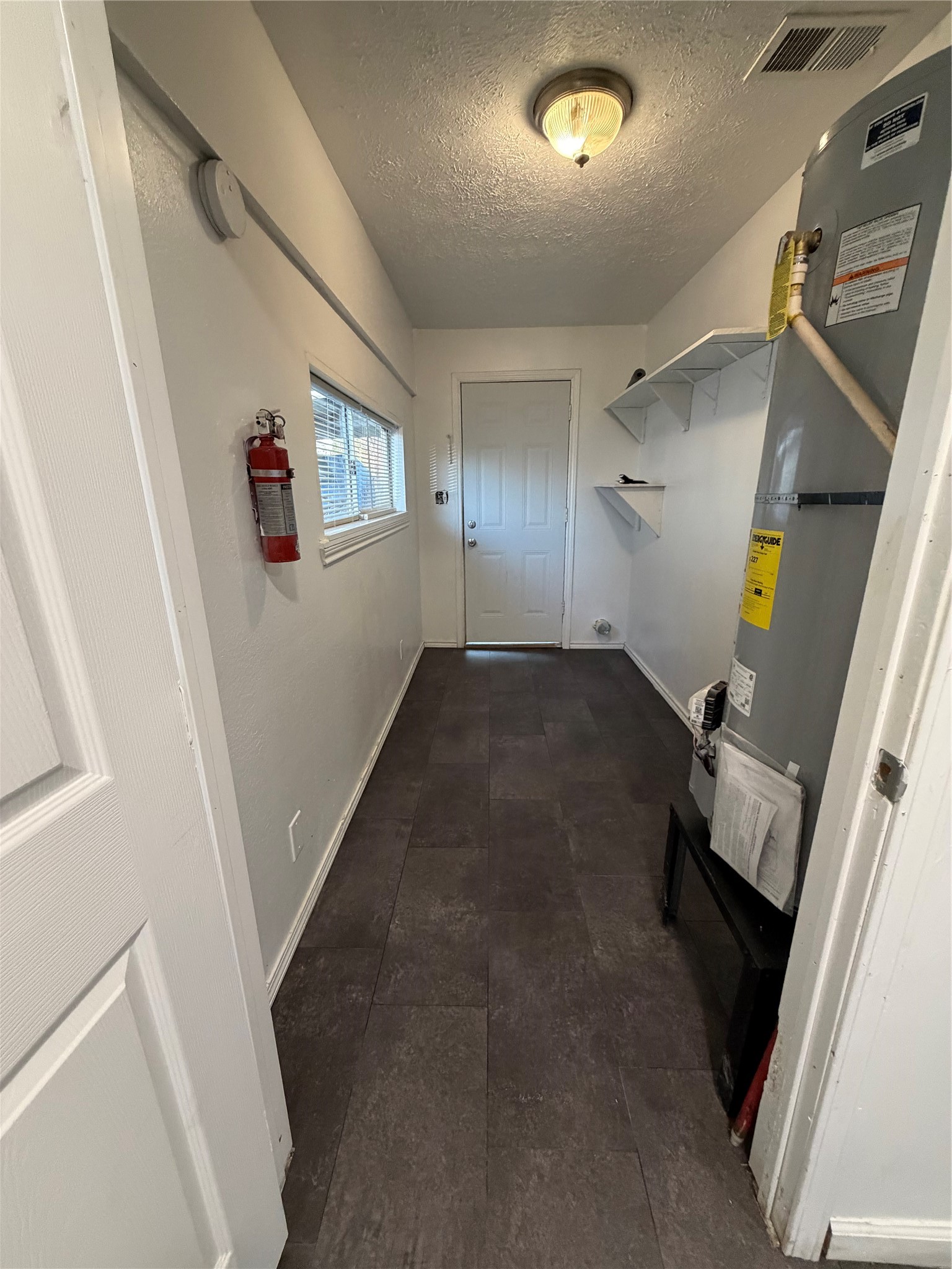 8308 Lenore Street Houston, TX 77017 - Photo 18 of 23 In house utility room, located next to dining space, leads to the back door.