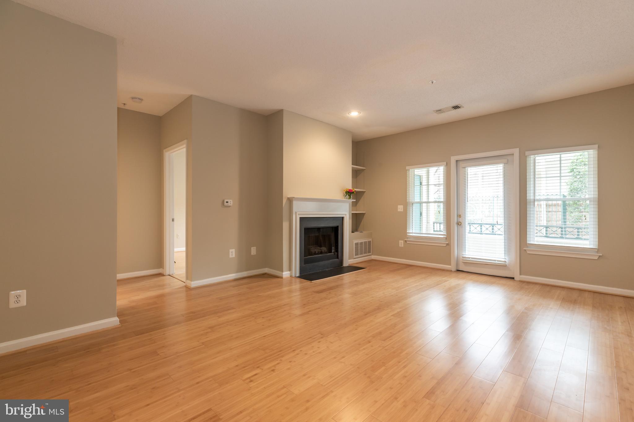 12012 Taliesin Place, Unit 14 Reston, VA 20190 - Photo 9 of 30 BUILT IN SHELVING TO RIGHT OF FIRE PLACE