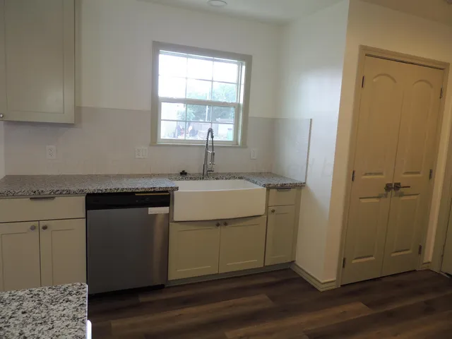 a utility room with cabinets washer and dryer