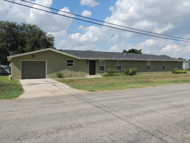 a view of the house with a yard