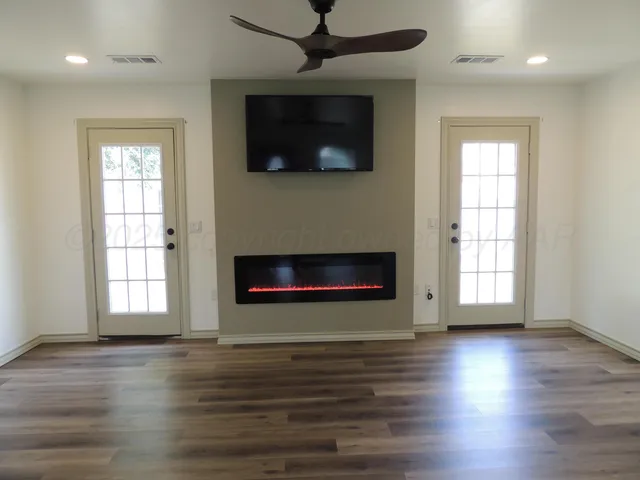 a living room with a flat screen tv and a fireplace