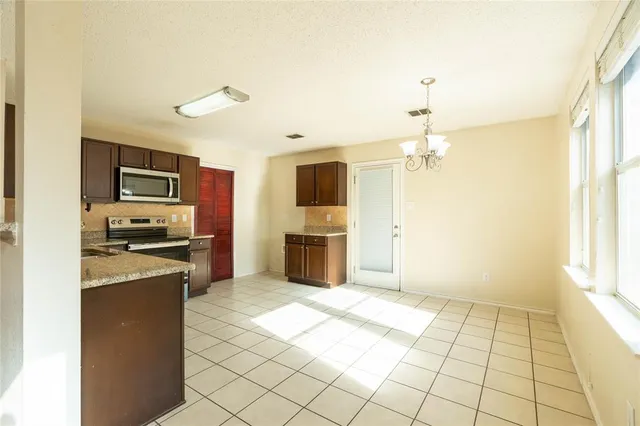 a kitchen with a sink a counter top space stainless steel appliances and cabinets