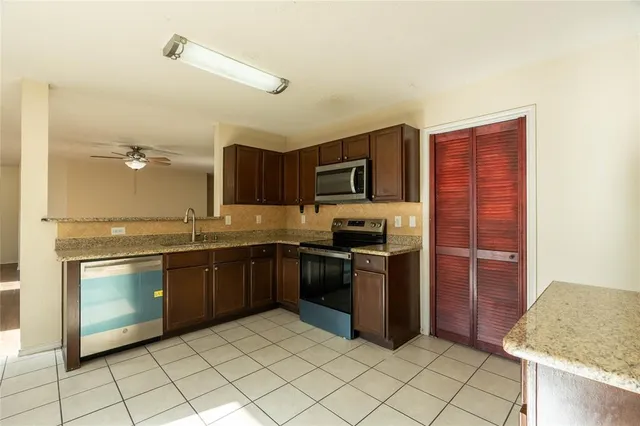 a kitchen with stainless steel appliances granite countertop a refrigerator and a sink