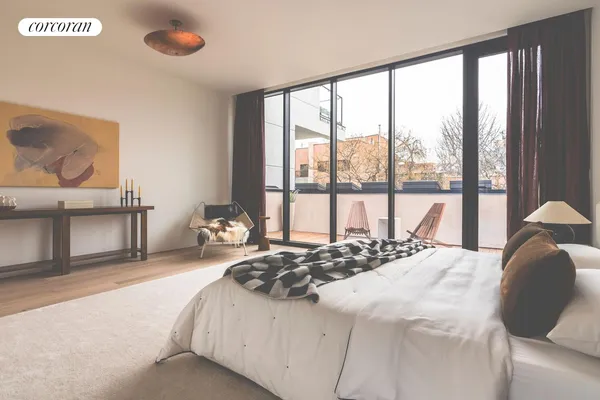 a bedroom with a bed and a large window