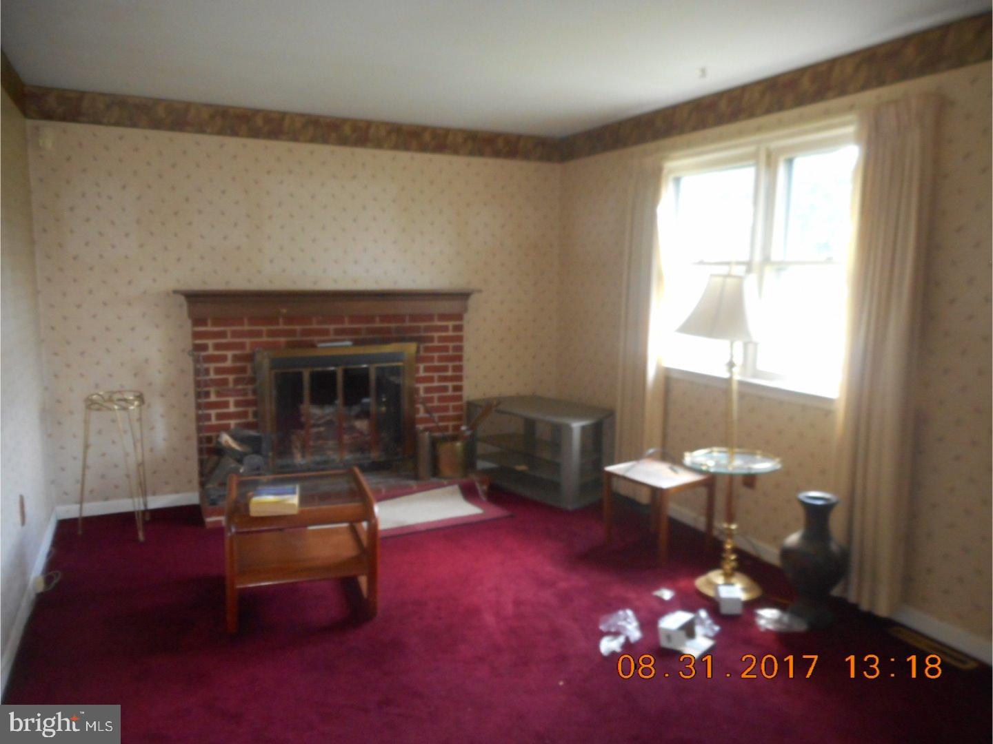 6 Valley Forge Road New Castle, DE 19720 - Photo 10 of 13 a living room with furniture a rug and a fireplace