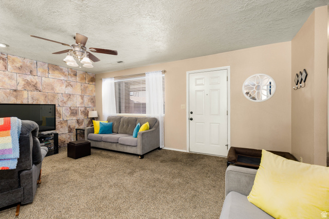 3707 Gates Circle Santa Clara, UT 84765 - Photo 5 of 19 Carpeted living area with a textured ceiling and a ceiling fan