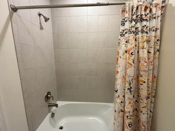 a bathroom with a bathtub and shower