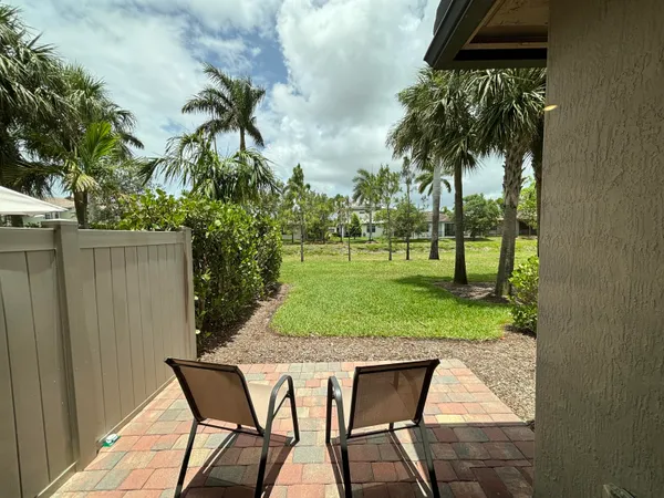 a view of a backyard with a garden and potted plants