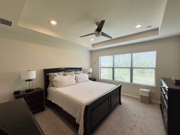 a bedroom with a large bed and a large window