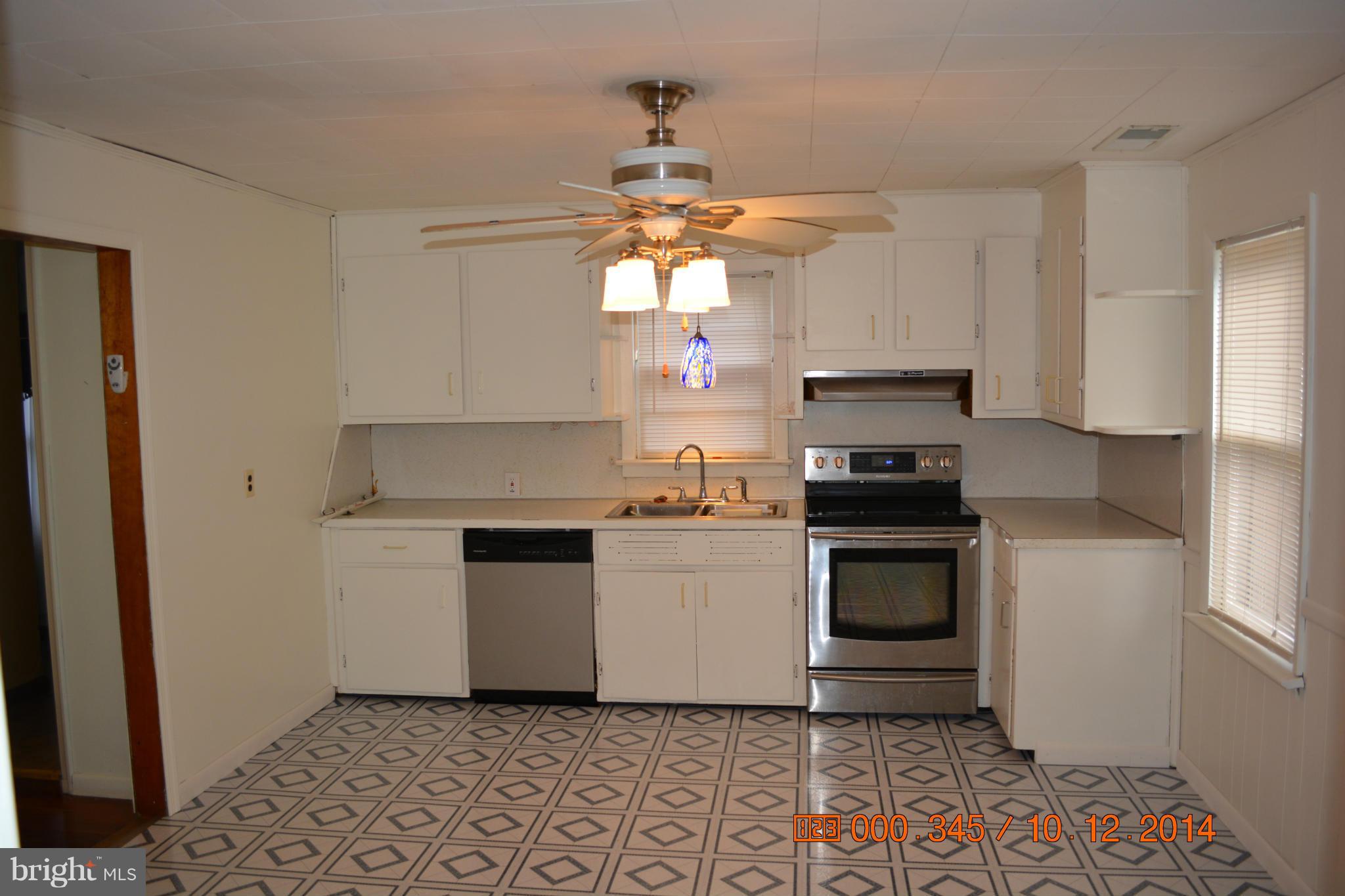 13106 Mercersburg Road Clear Spring, MD 21722 - Photo 5 of 11 a kitchen with a stove a sink and a refrigerator