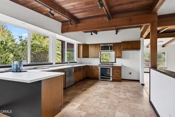 a kitchen with stainless steel appliances granite countertop a sink and a stove
