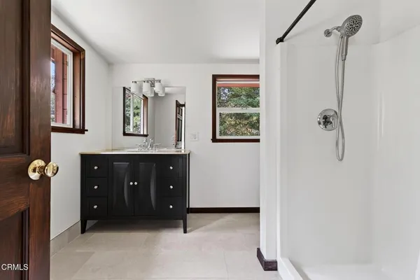 a bathroom with a tub sink and mirror