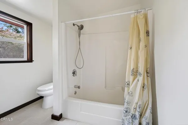 a bathroom with a shower a toilet and a shower