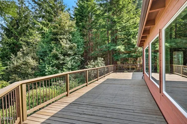 a view of balcony with wooden floor and fence