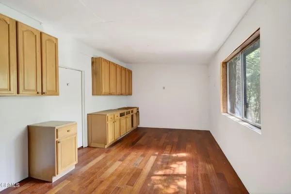 a room with a window and wooden floor
