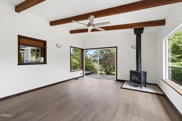 a view of room with furniture window and wooden floor