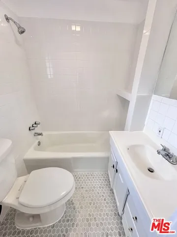 a bathroom with a tub sink and toilet