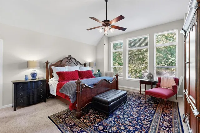 a bedroom with furniture and a large window