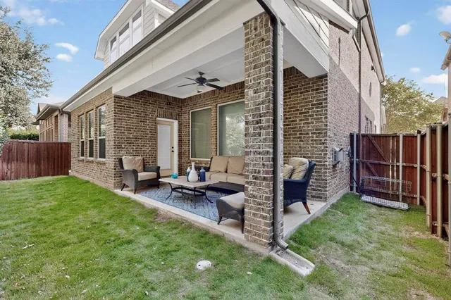 a view of backyard with deck and outdoor seating
