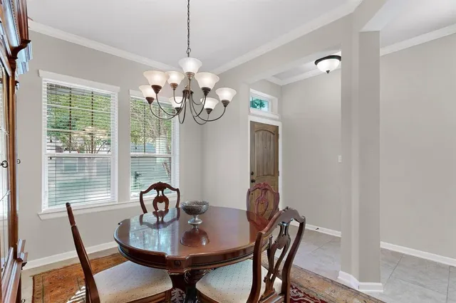 a view of a dining room with furniture a chandelier and wooden floor