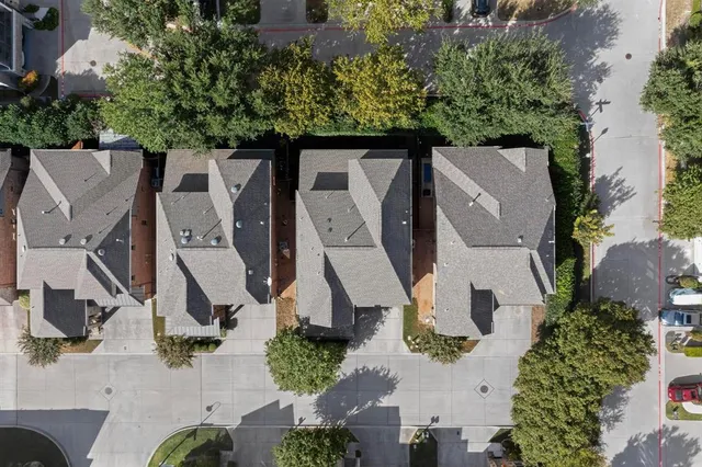 an aerial view of residential house with outdoor space and trees