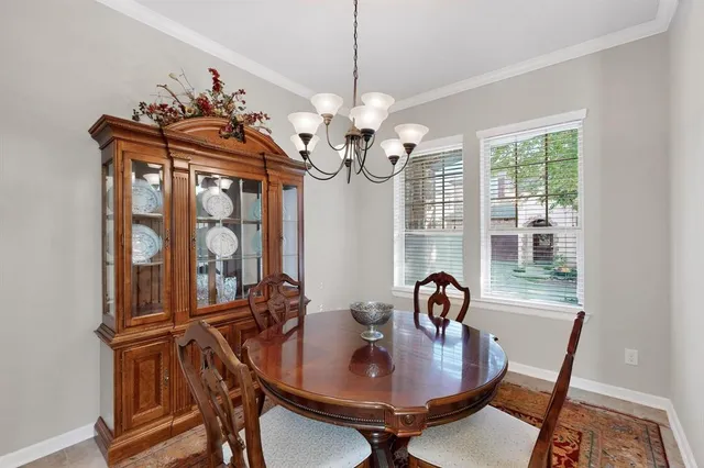a view of a dining room with furniture and chandelier