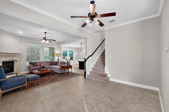 a living room with furniture and a chandelier
