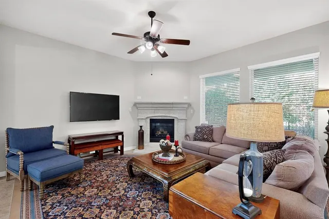 a living room with furniture fireplace and window