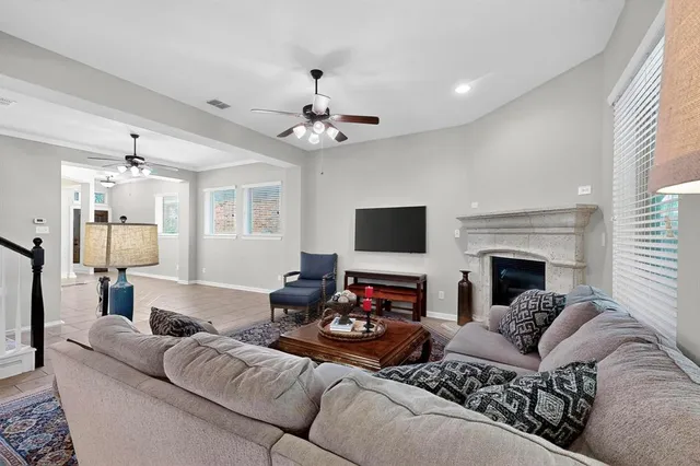 a living room with furniture a fireplace and a flat screen tv
