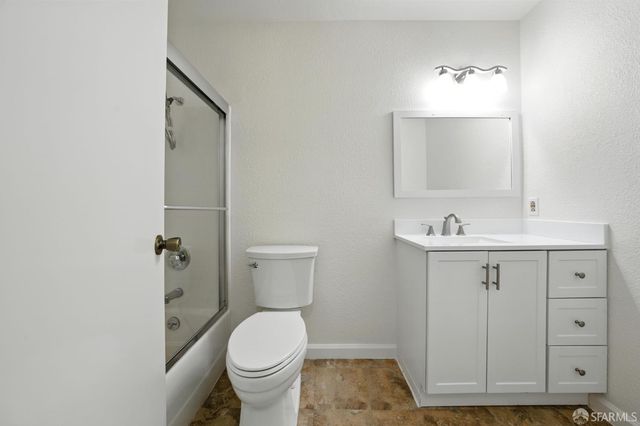 a bathroom with a sink toilet and mirror