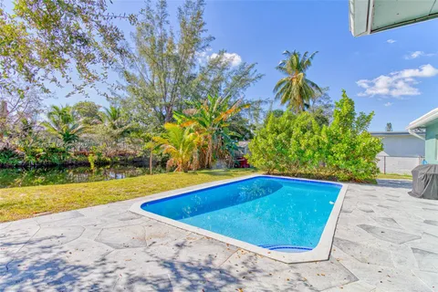 a view of a room with wooden floor and chandelier