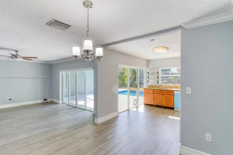 a kitchen with stainless steel appliances granite countertop a stove a sink dishwasher and a refrigerator with wooden floor