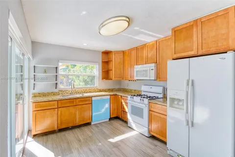 a kitchen with a sink stove and refrigerator