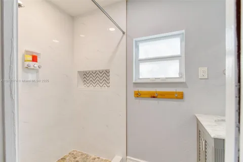 a bathroom with a sink mirror vanity and a bathtub