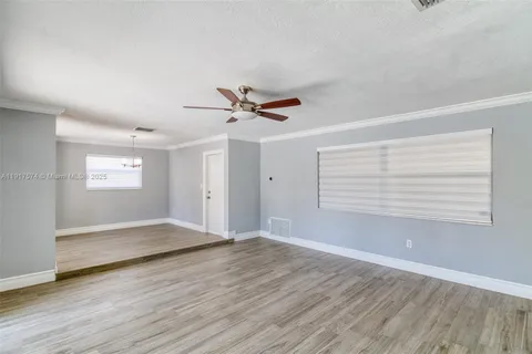 a view of room with a ceiling fan and window