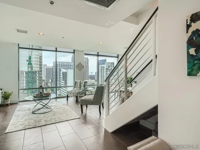 a living room with furniture and floor to ceiling window