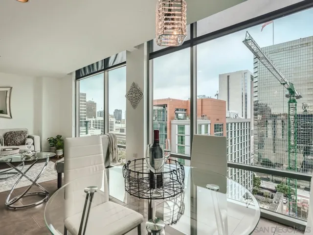 a living room with furniture and a floor to ceiling window