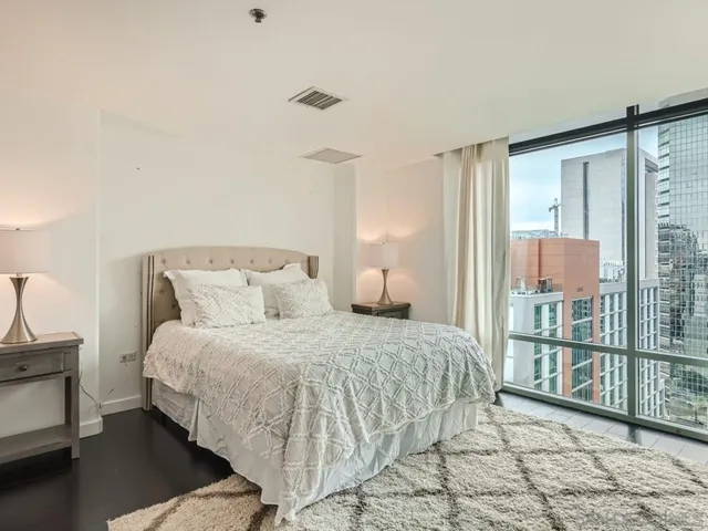 a bedroom with a bed and glass door