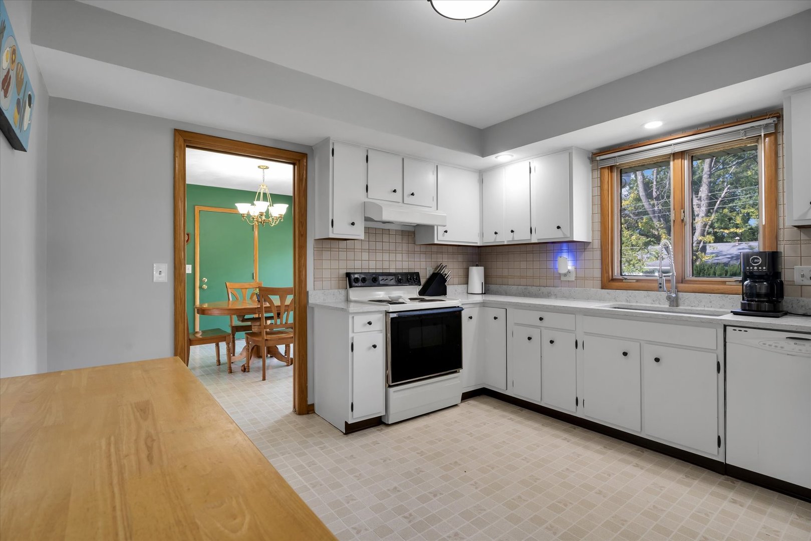 1110 Silver Street Urbana, IL 61801 - Photo 11 of 40 a kitchen with granite countertop white cabinets and white appliances