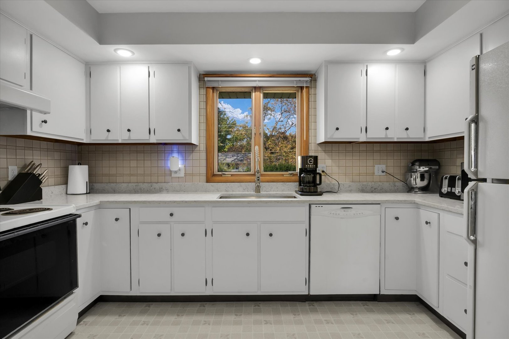 1110 Silver Street Urbana, IL 61801 - Photo 12 of 40 a kitchen with granite countertop white cabinets and window