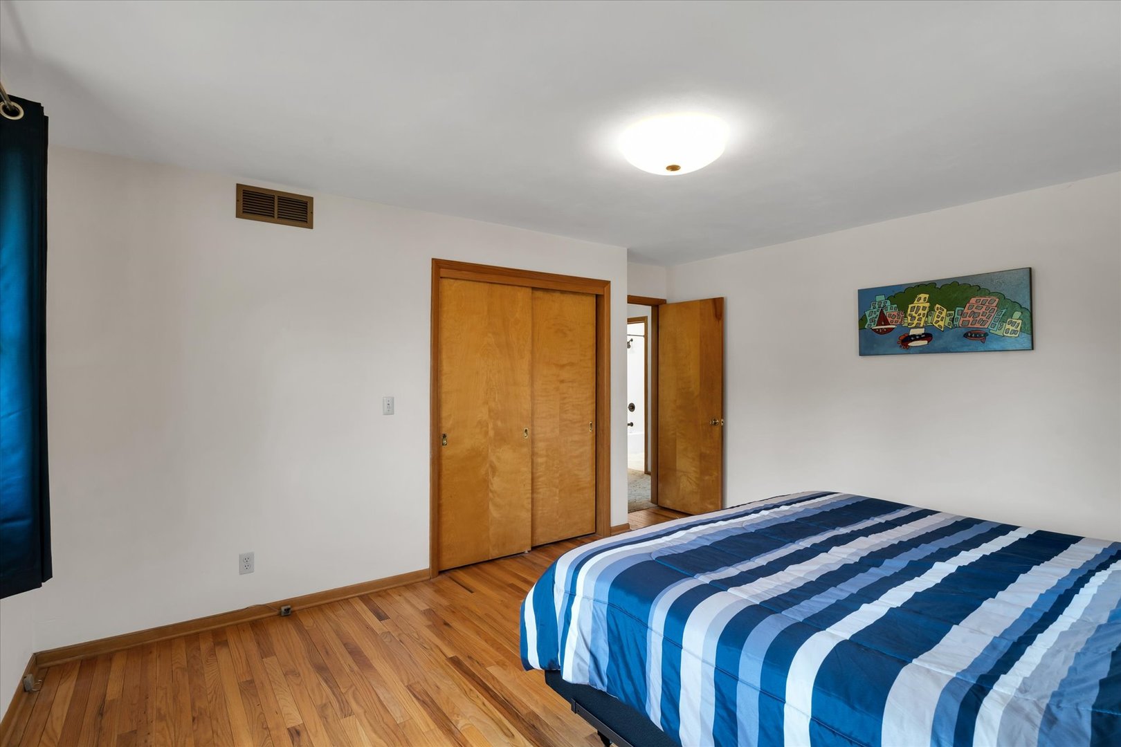 1110 Silver Street Urbana, IL 61801 - Photo 15 of 40 a bedroom with a bed and a painting on the wall
