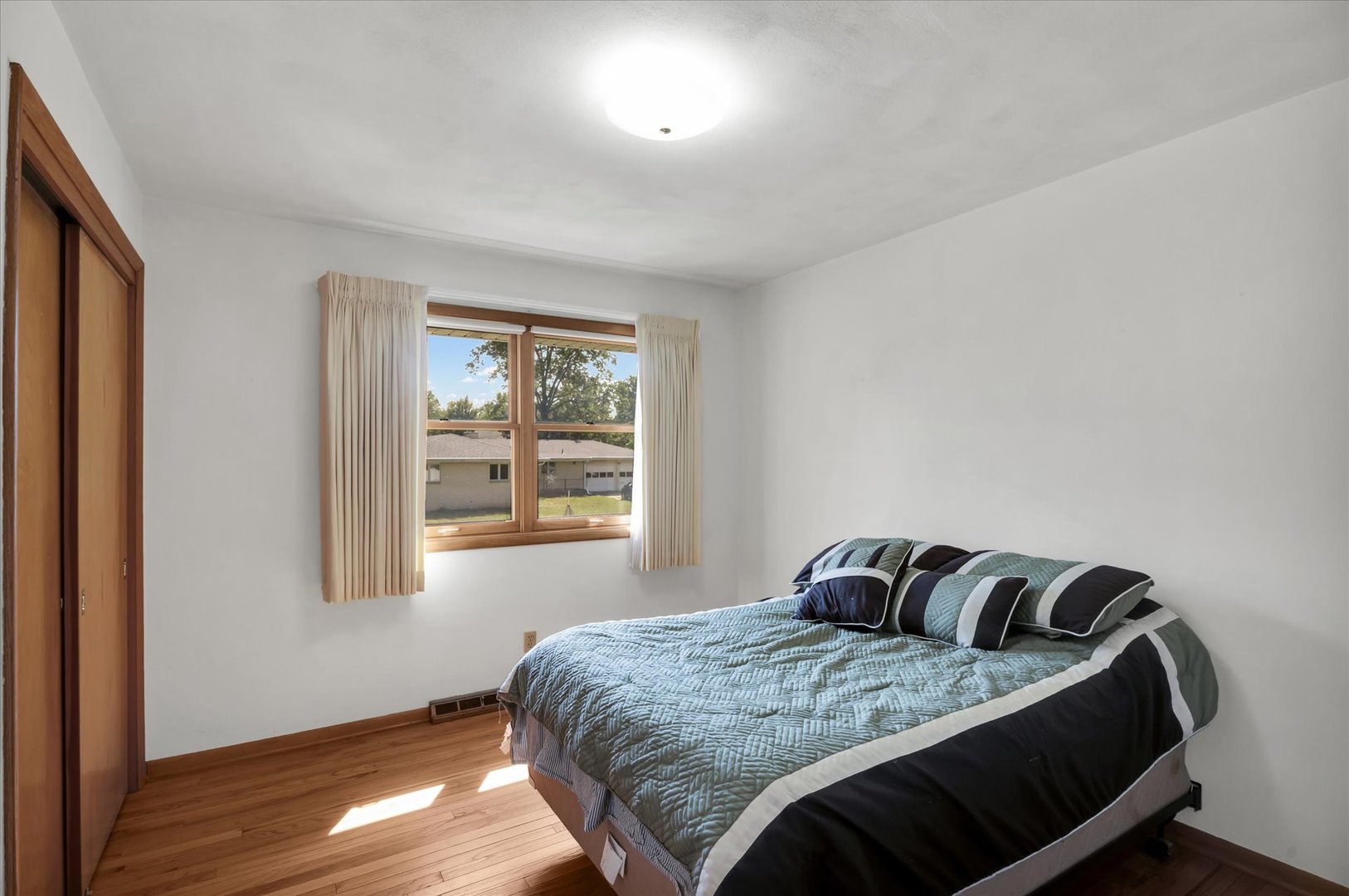 1110 Silver Street Urbana, IL 61801 - Photo 21 of 40 a bedroom with a bed and wooden floor