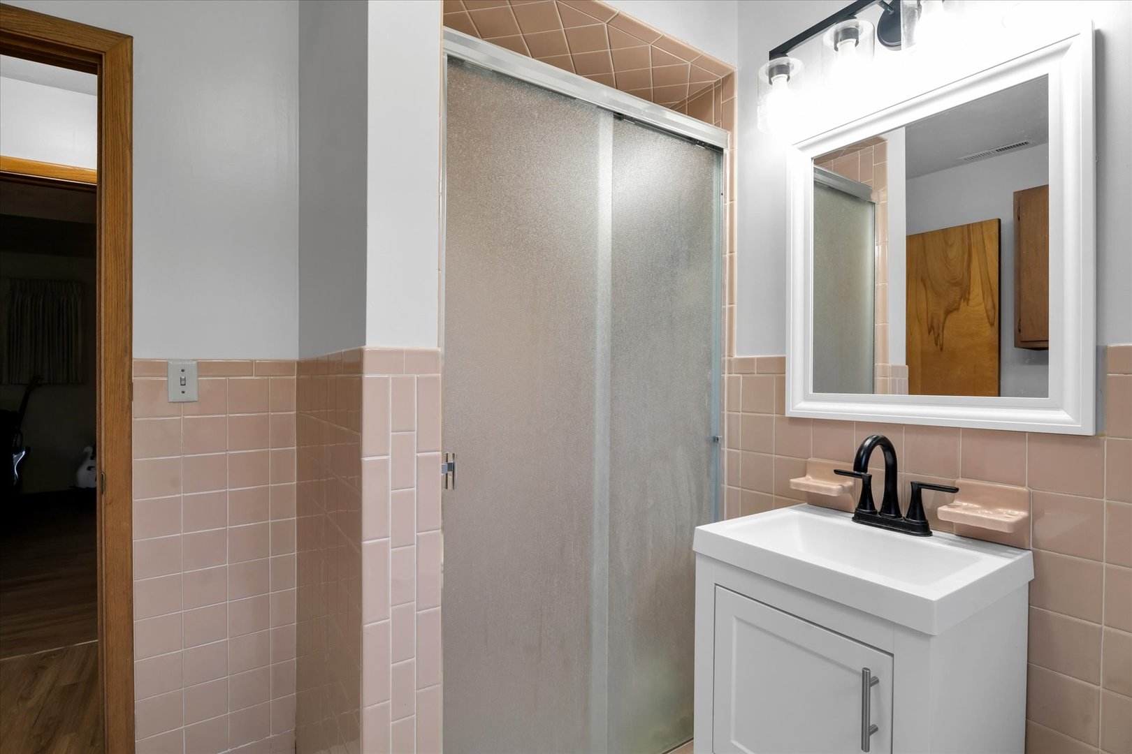 1110 Silver Street Urbana, IL 61801 - Photo 29 of 40 a bathroom with a sink a light fixture and a mirror