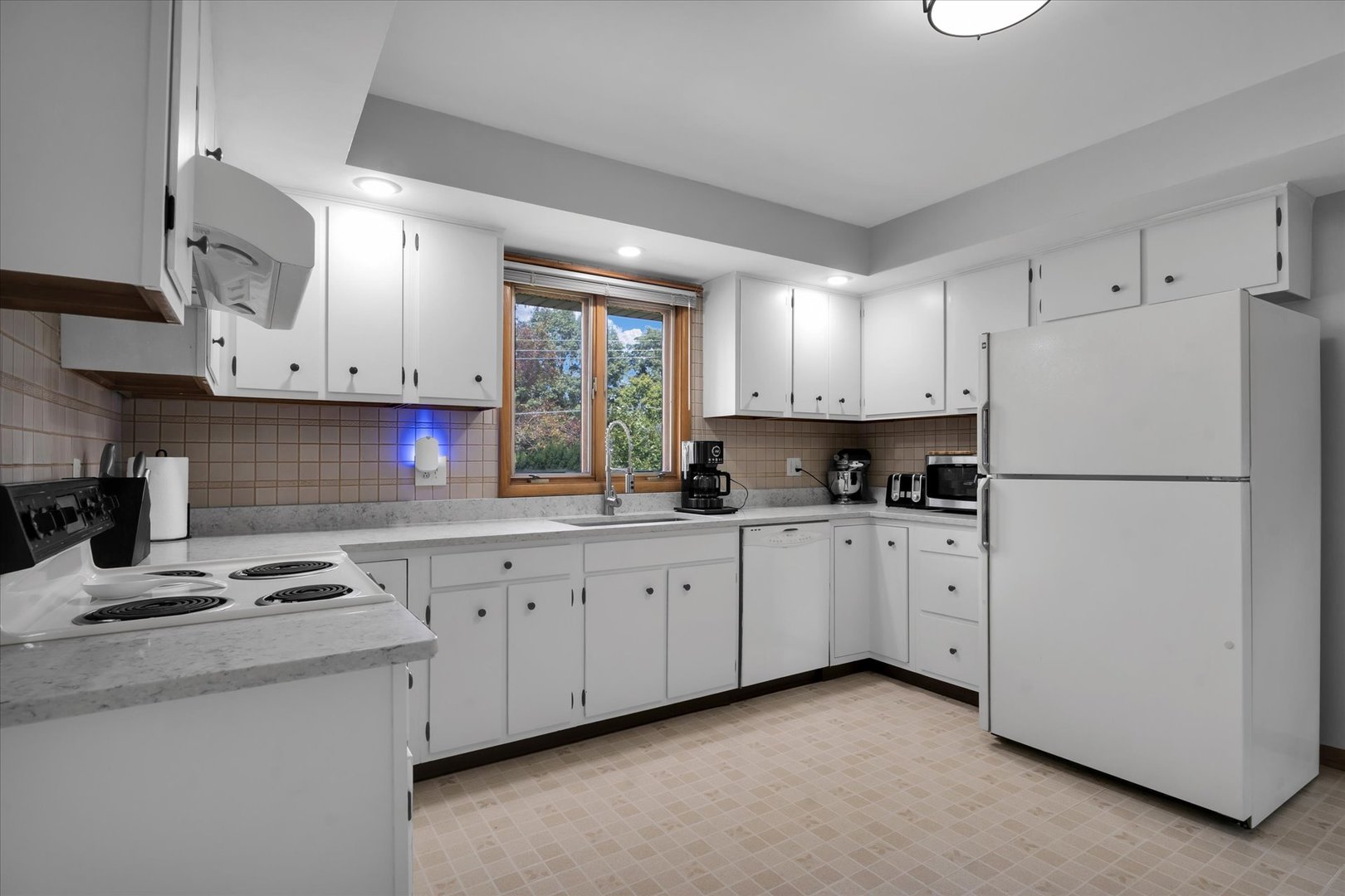 1110 Silver Street Urbana, IL 61801 - Photo 10 of 40 a kitchen with cabinets appliances a sink and a window