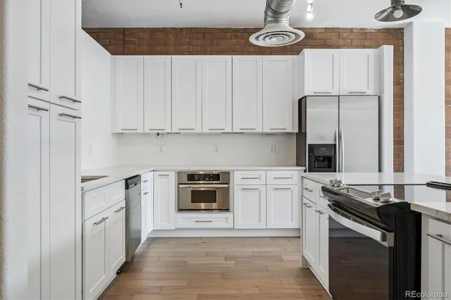 a kitchen with stainless steel appliances a stove a sink and cabinets