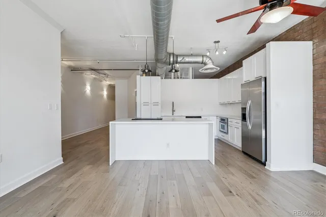 a view of kitchen with refrigerator microwave and stove