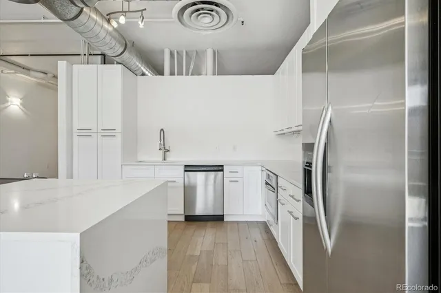 a kitchen with stainless steel appliances a refrigerator and a stove