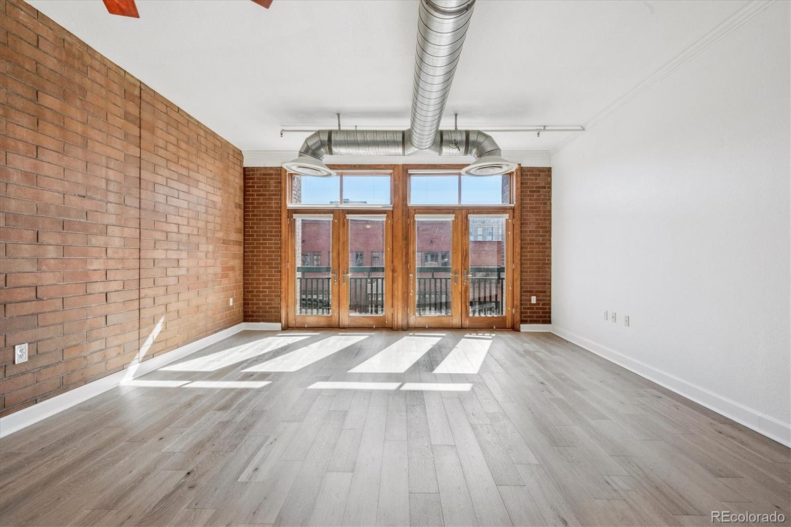 2245 Blake Street, Unit F Denver, CO 80205 - Photo 18 of 38 a view of an empty room with a window