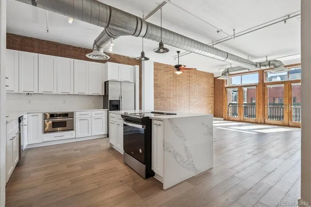 a kitchen with stainless steel appliances granite countertop a stove and refrigerator