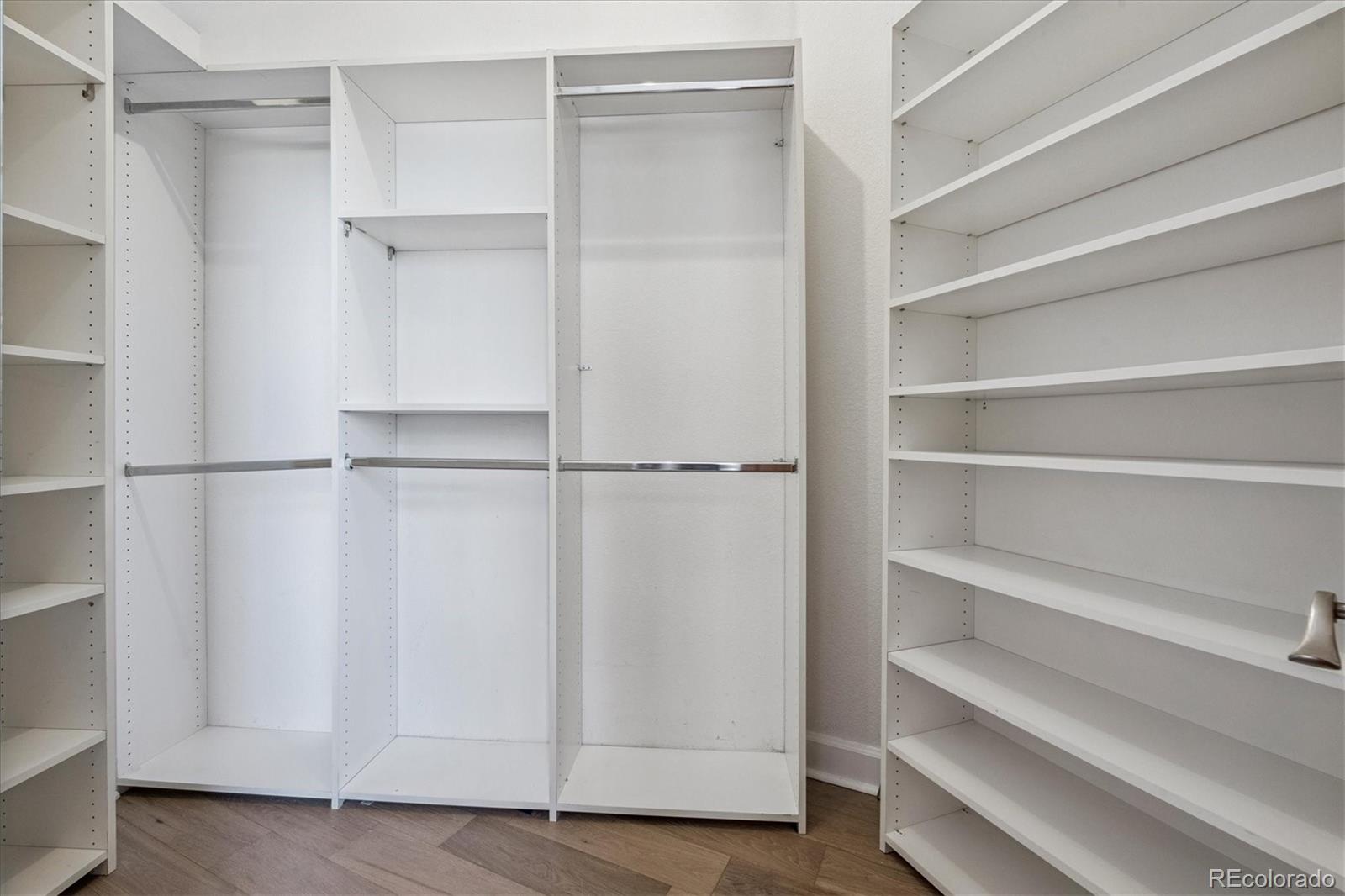 2245 Blake Street, Unit F Denver, CO 80205 - Photo 29 of 38 a view of walk in closet with empty racks